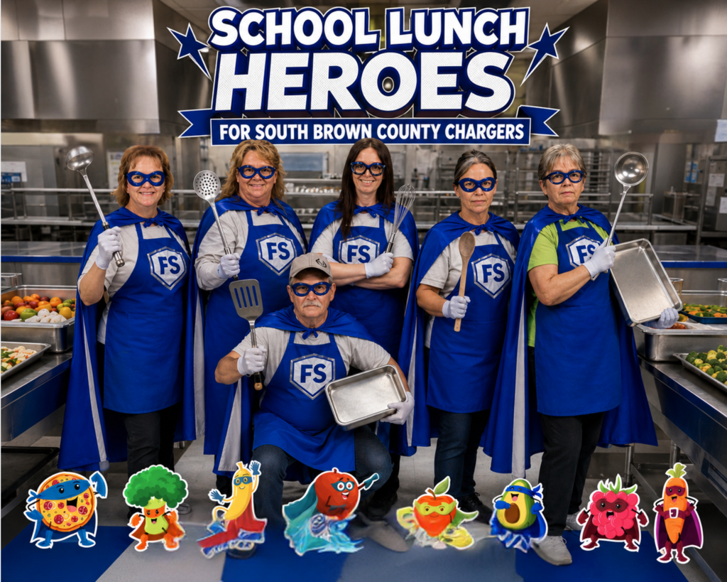 Group of individuals in blue capes and aprons, holding utensils, standing in a kitchen.