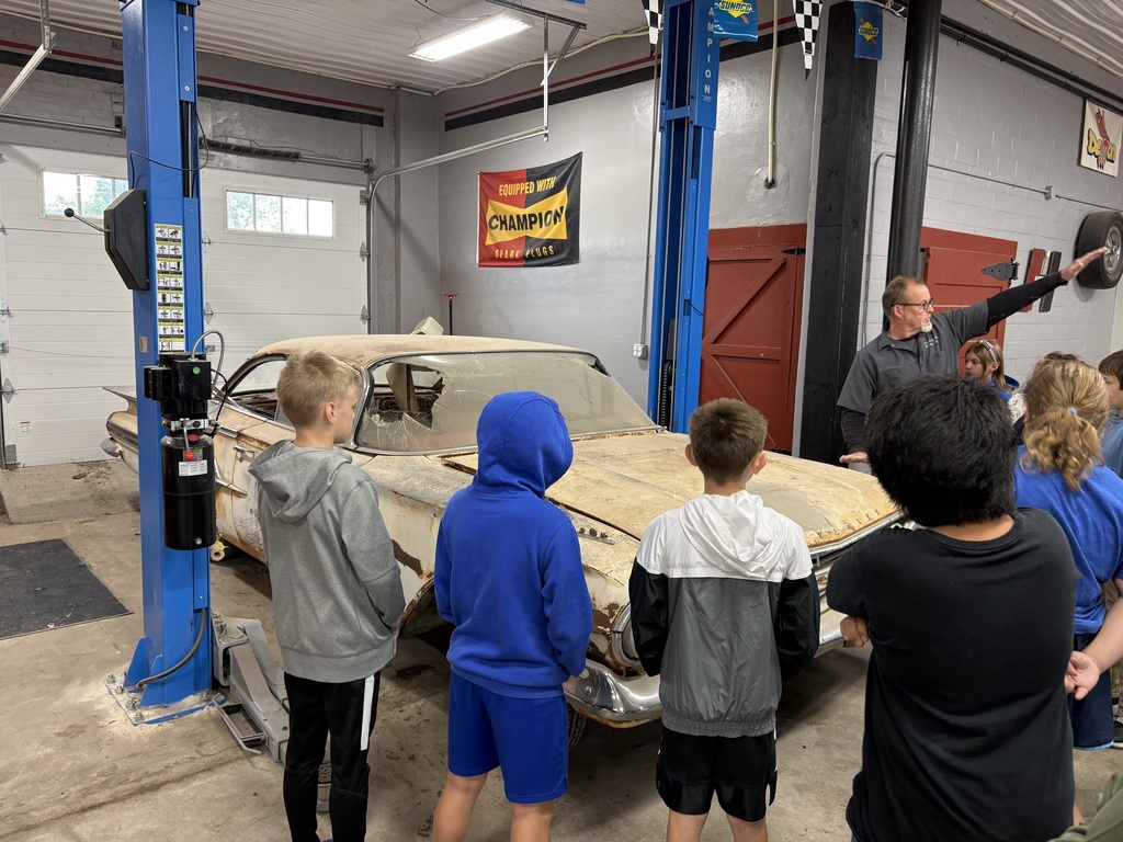 5th grade learning about classic car restoration during career exploration field trip. 