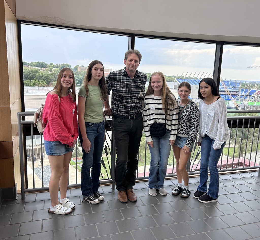 5 high school students pose with TIm Carpenter at the Kansas Student Union.