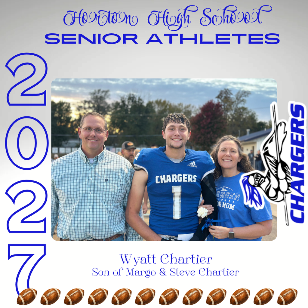 Three adults, two men and a woman, stand beside a football player wearing a blue jersey. Trees and a building are in the background.