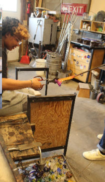 Glass blowing field trip - students shaping glass