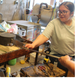 Glass blowing field trip - students shaping glass