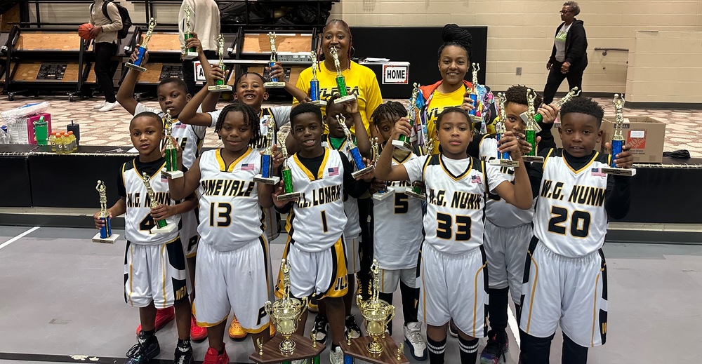 team holding trophies with coaches