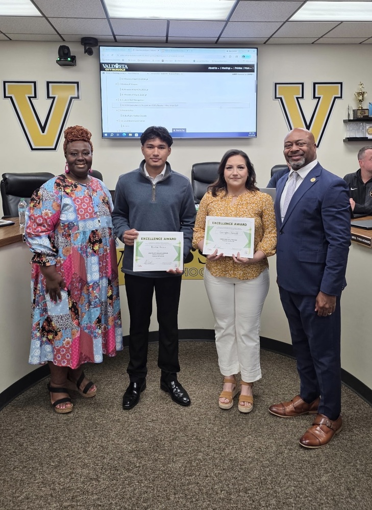 student and teacher with superintendent and board chair with certificates