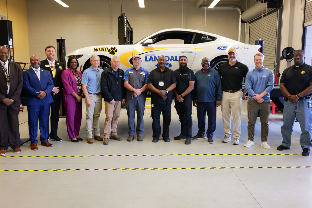 group photo in front of car