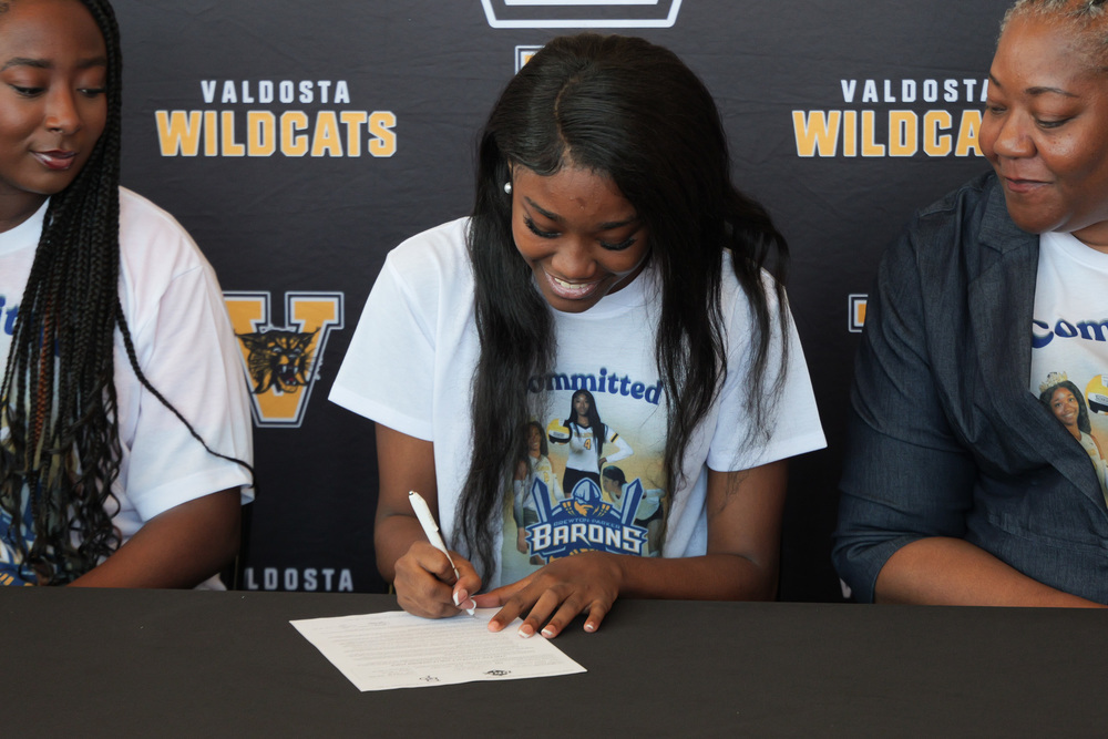 student signing paper 