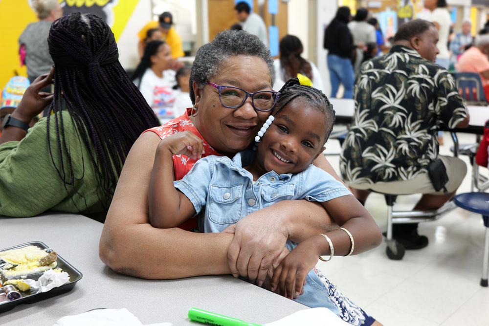 Grandparent with her grandchild in the lunchroom