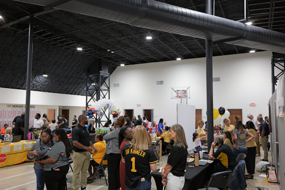 wide shot of registration event, people at tables
