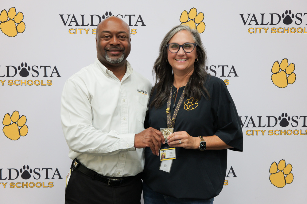 Kaci holding coin with Dr. Lockhart