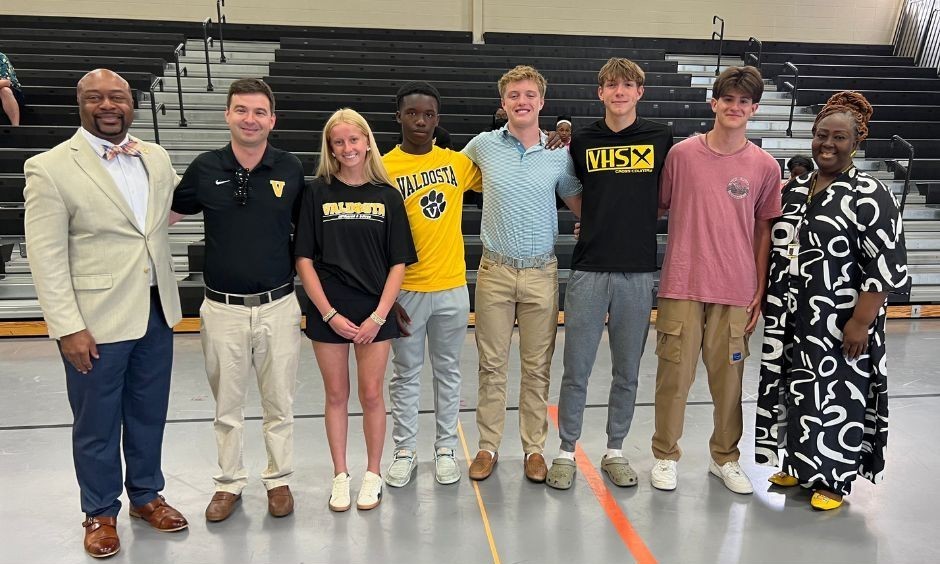 Group photo of students with Superintendent, coach and Board chair