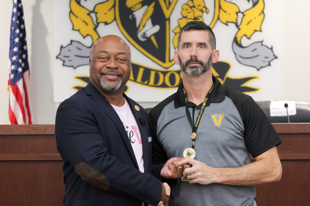 Mr. Mullins, holding coin of victory with Dr. Lockhart