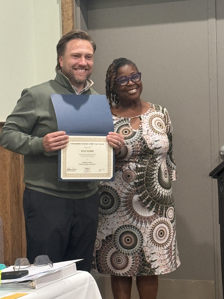 Mr. Elder with group representative, holding certificate