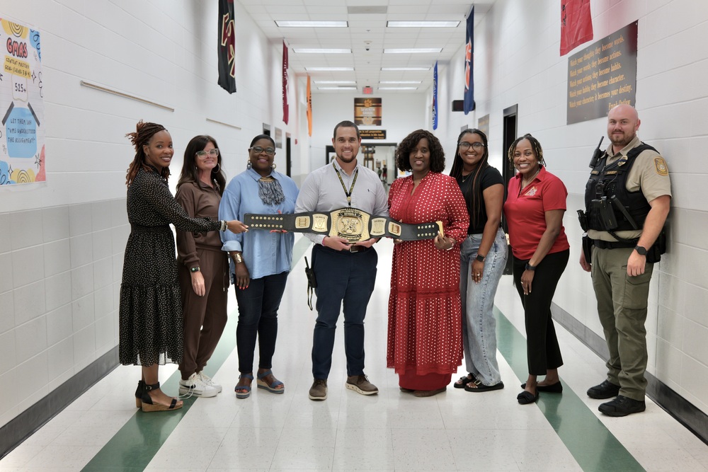 group photo of staff with belt