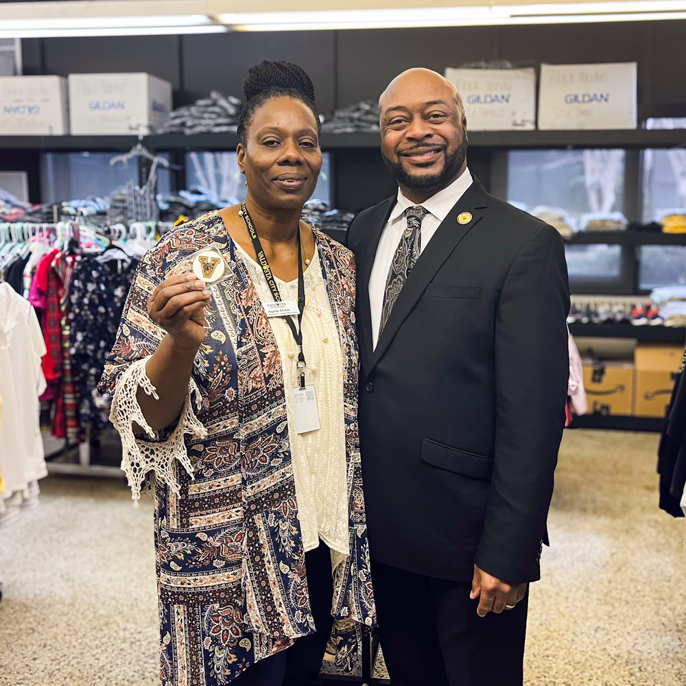 Ms. Stokes with Dr. Lockhart, holding coin