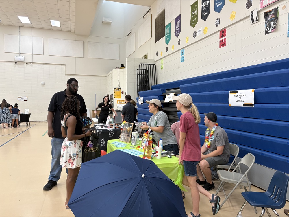 family engaging at a community partner table