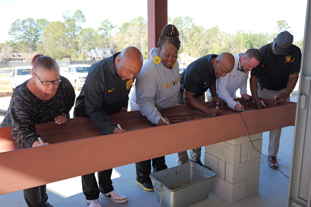 VBOE members and superintendent signing the final beam