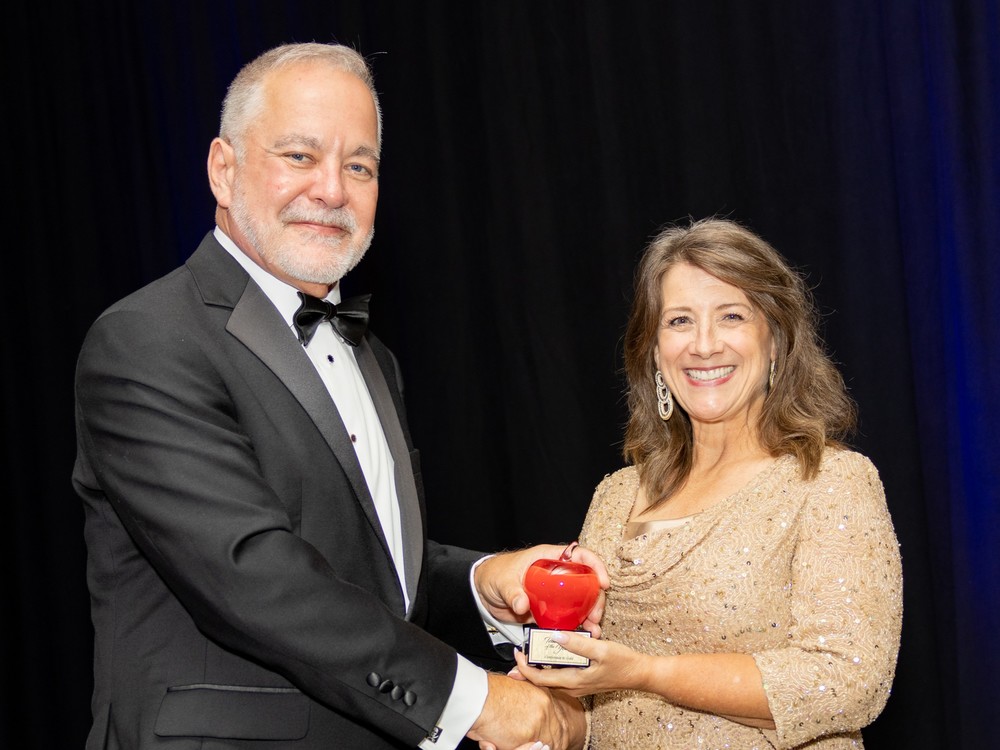 Mrs. Evans with Superintendent Woods, holding award