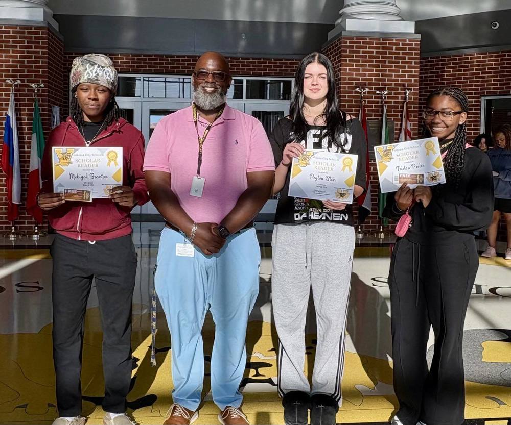 students holding certificates for reading recognition