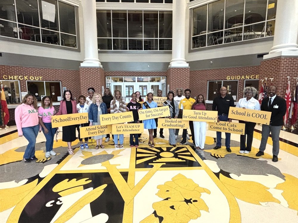 group photo of participants holding sign