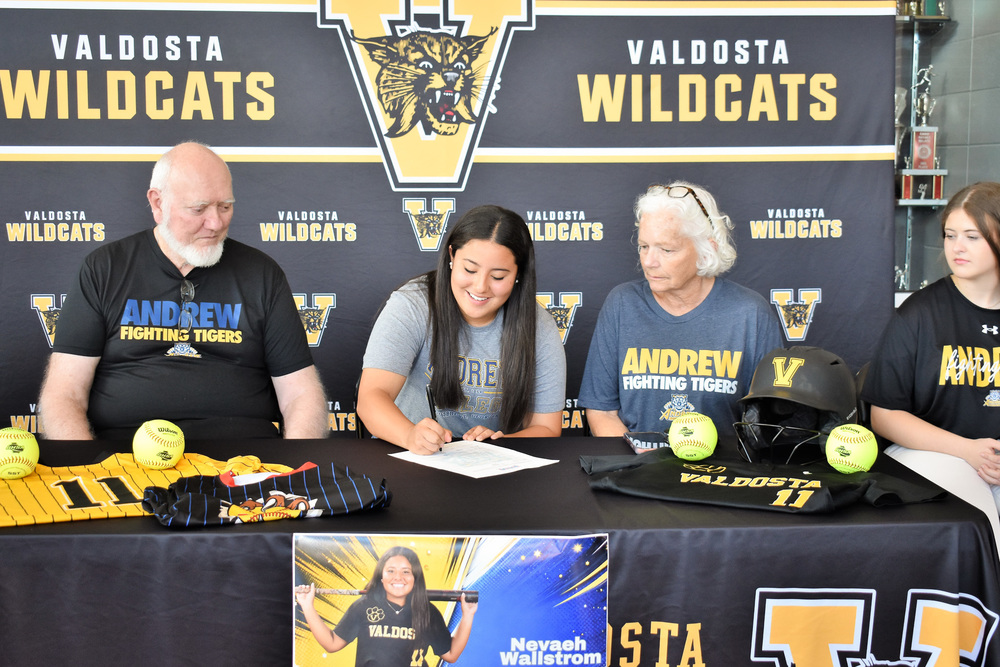 student signing paperwork for scholarship