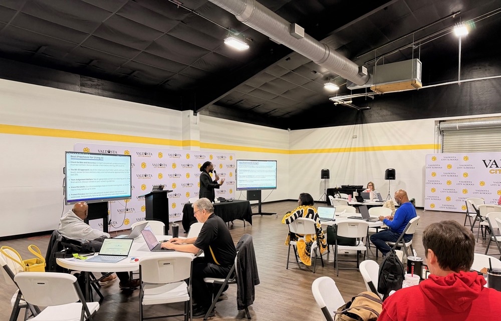 session with speaker and participants sitting at tables
