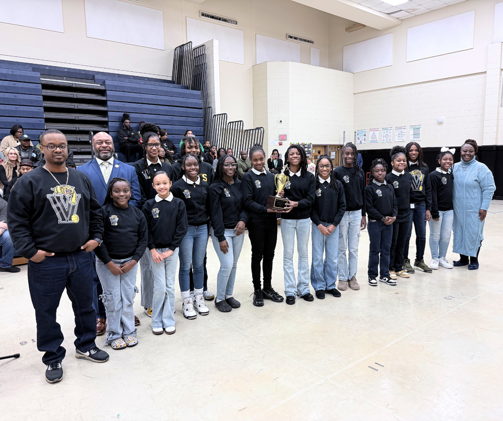 Team standing with coach, superintendent and Board Chair