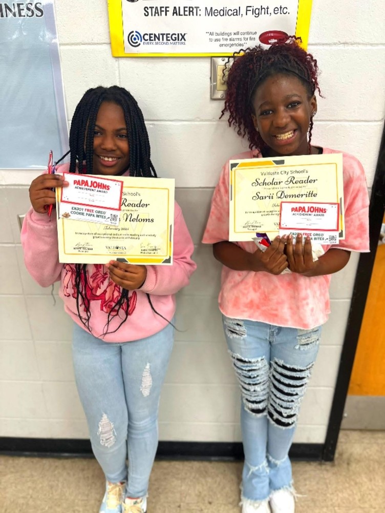 students holding certificates for reading recognition