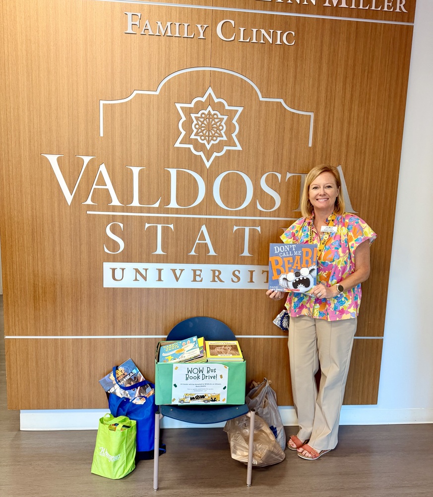Dr. Crawford holding donation
