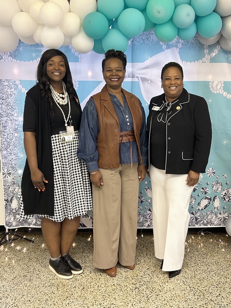 Donor with AP and Principal in front of backdrop