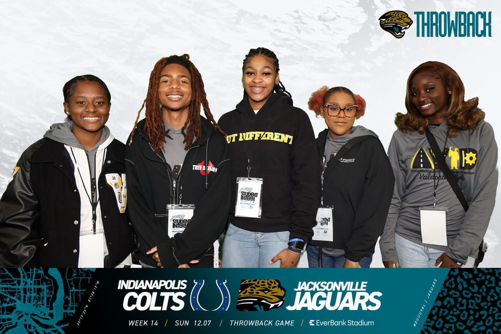 Students in front of Jaguar backdrop
