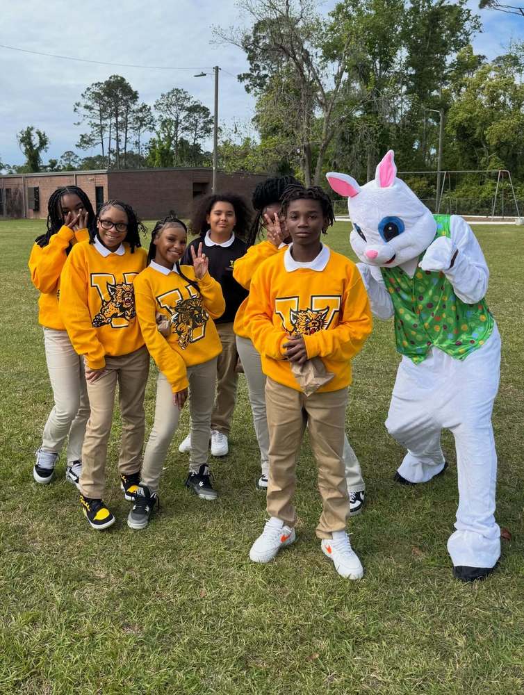 students standing with Easter Bunny