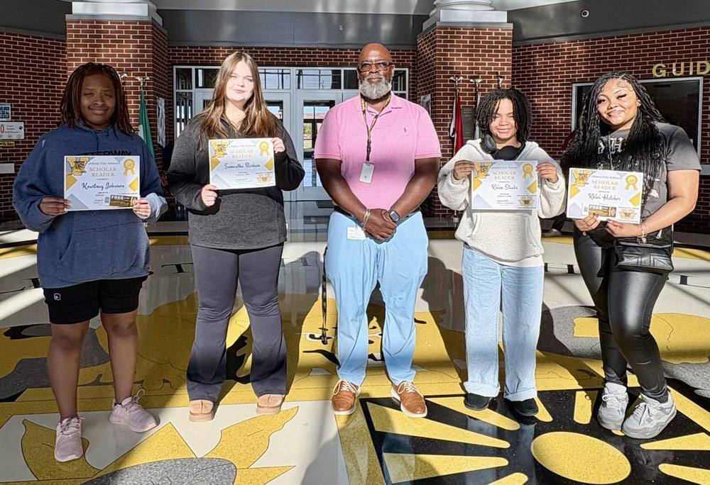 students holding certificates for reading recognition
