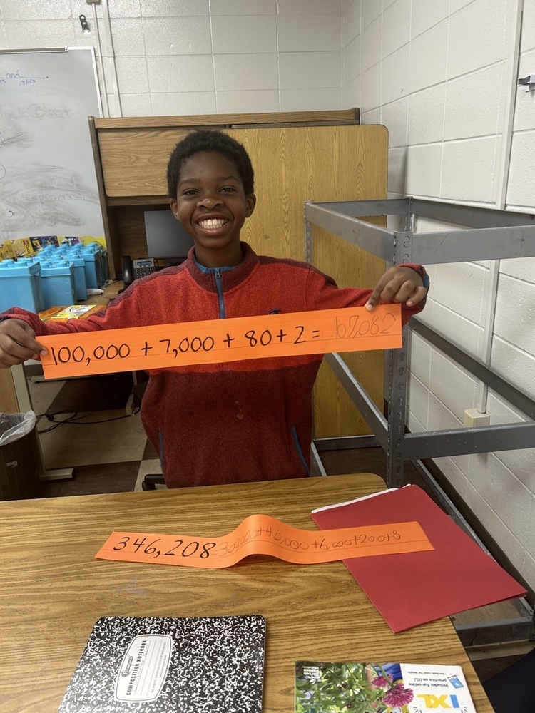 student holding math sign
