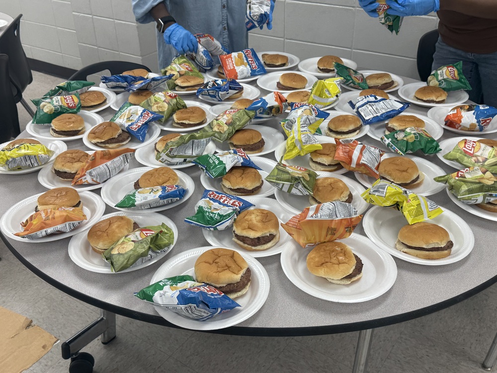 table full of hamburgers and chips