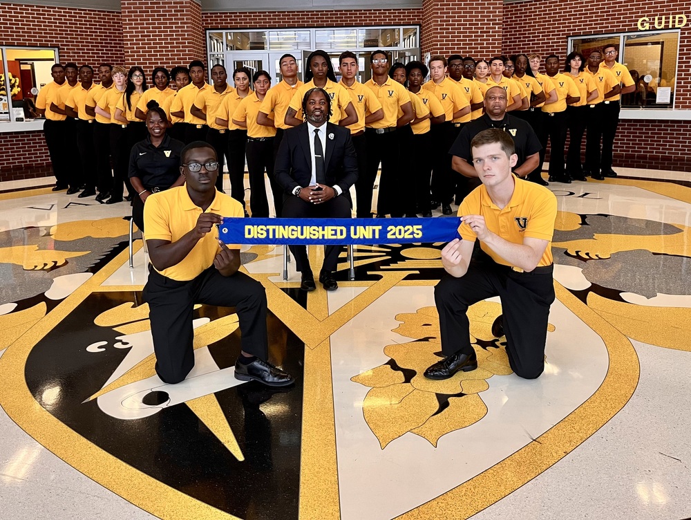 NJROTC in group photo with banner for Distinguished Unit 2025