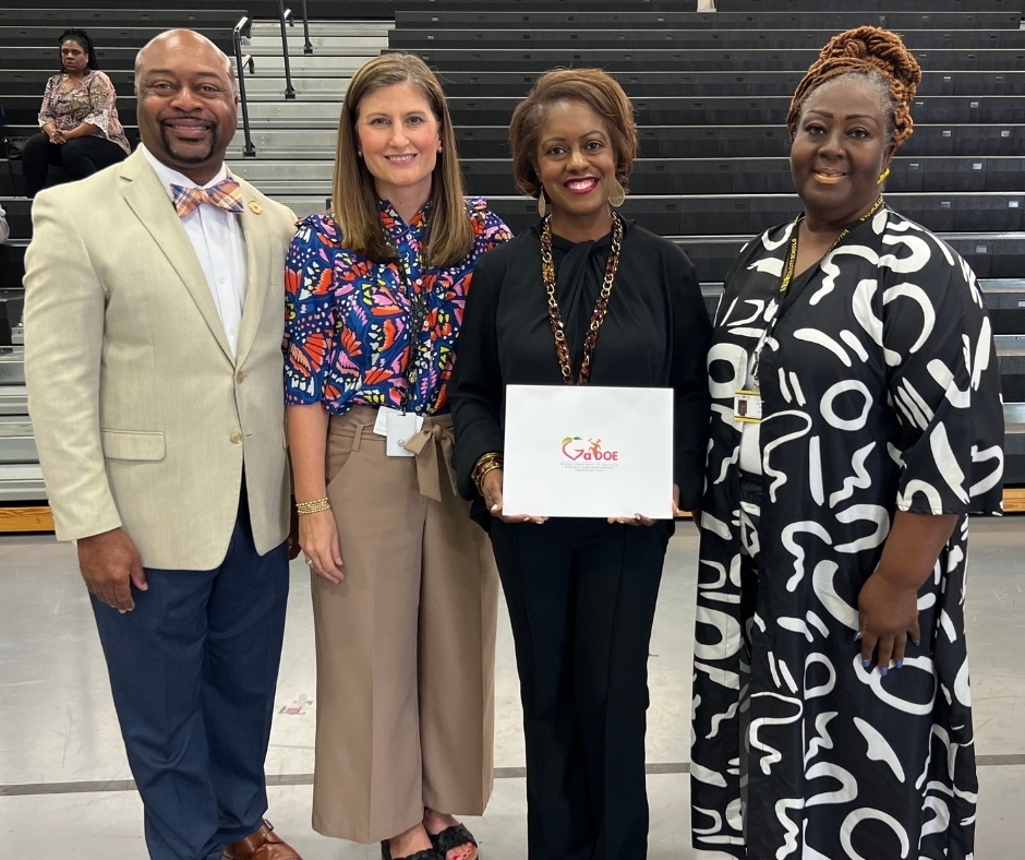 Student's teacher with ESOL rep, board chair, and superintendent