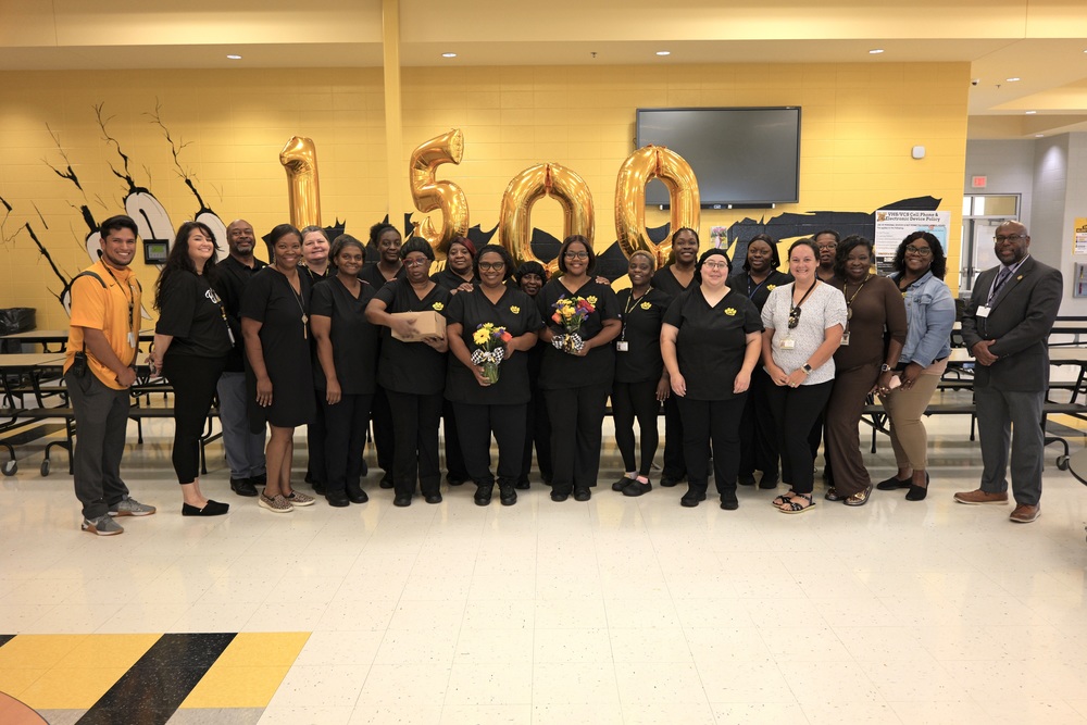 Group photo of cafeteria team with admin