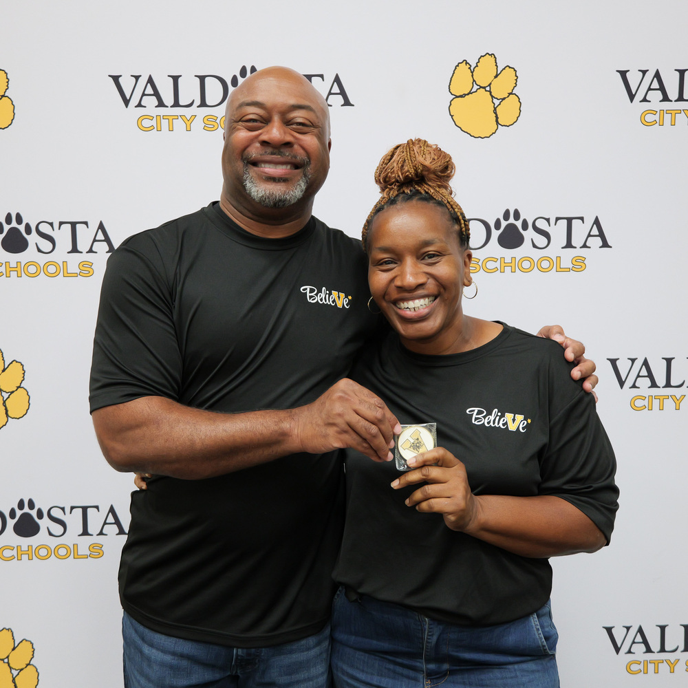 Greta holding coin with Dr. Lockhart