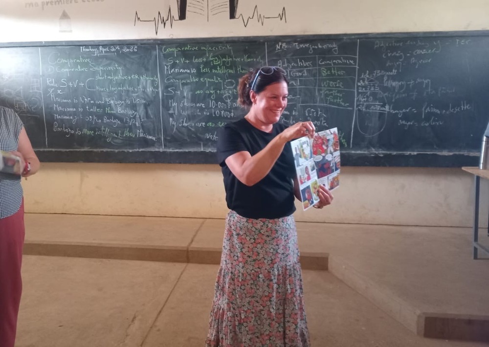 Mrs. Roberts showing book at front of the classroom