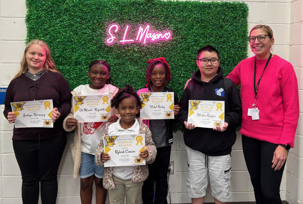 students holding certificates for reading recognition