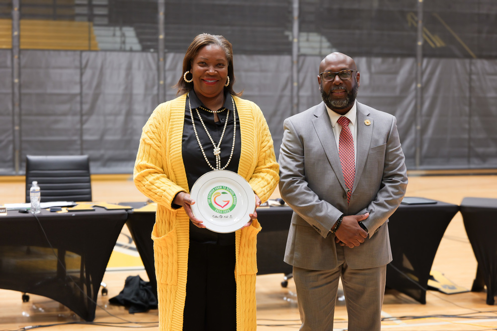 Dr. Witherspoon with Chef Hayes, holding award