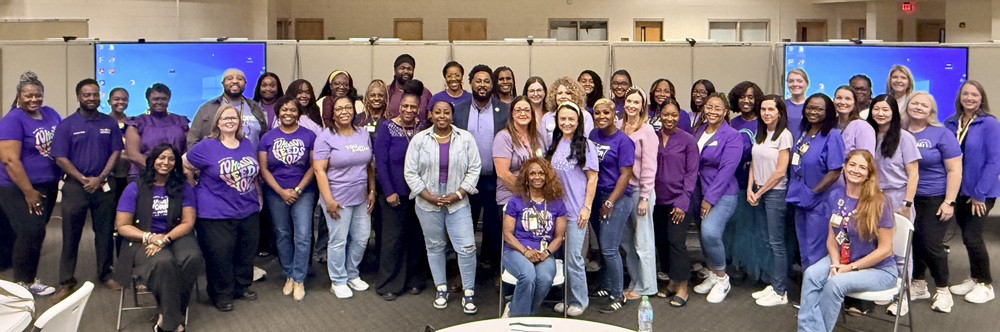 group photo of participants wearing purple