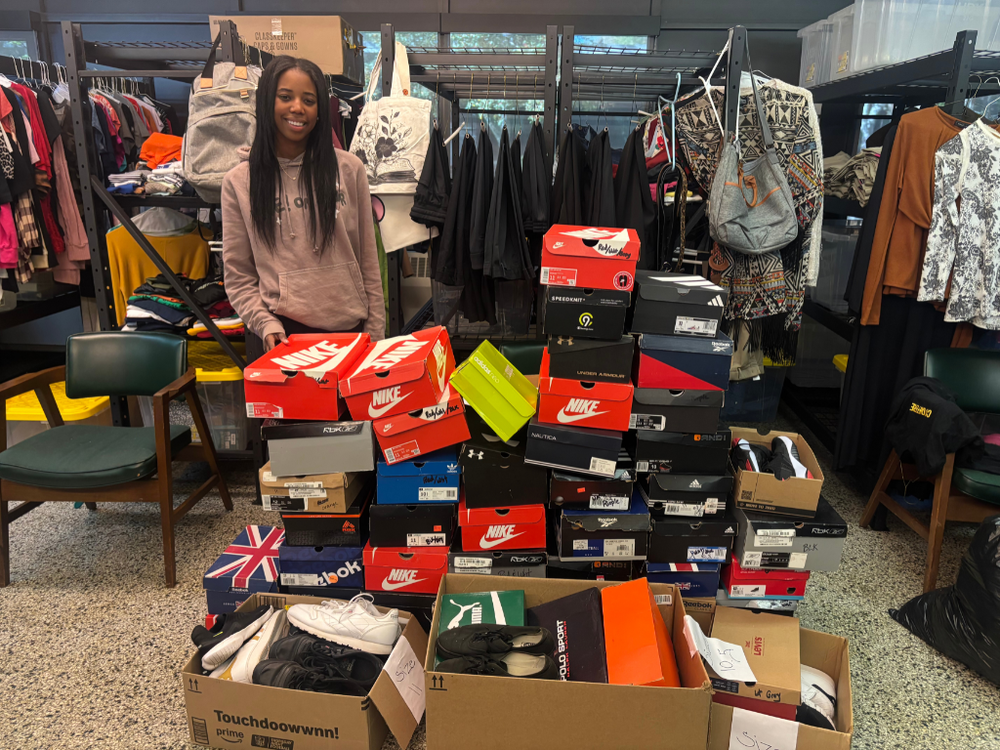 Student standing with shoes donation