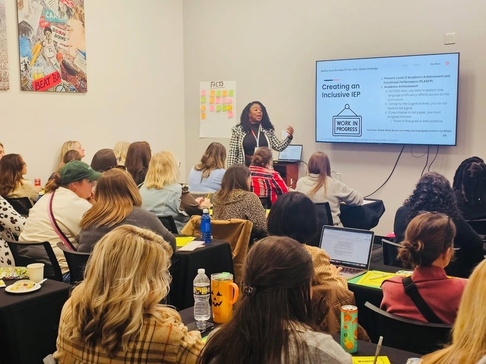 Presenter in front of audience with presentation