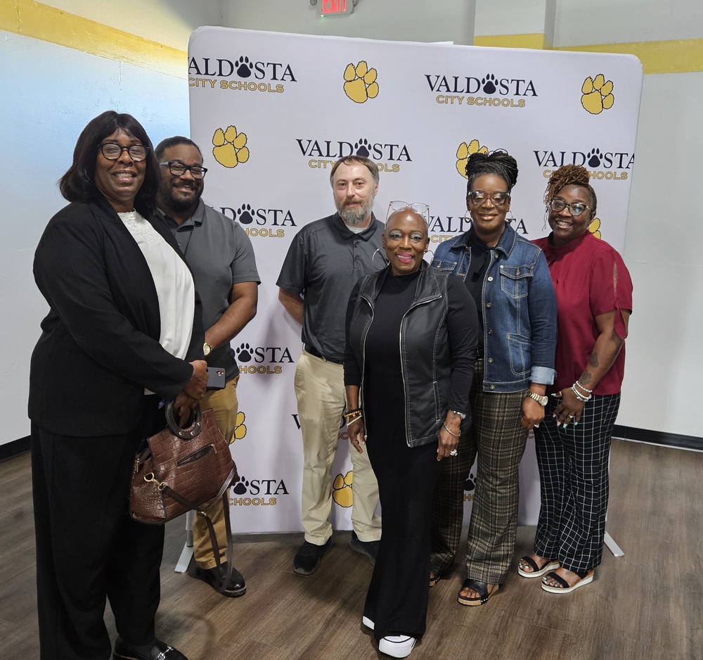 Group photo of participants in front of VCS Backdrop