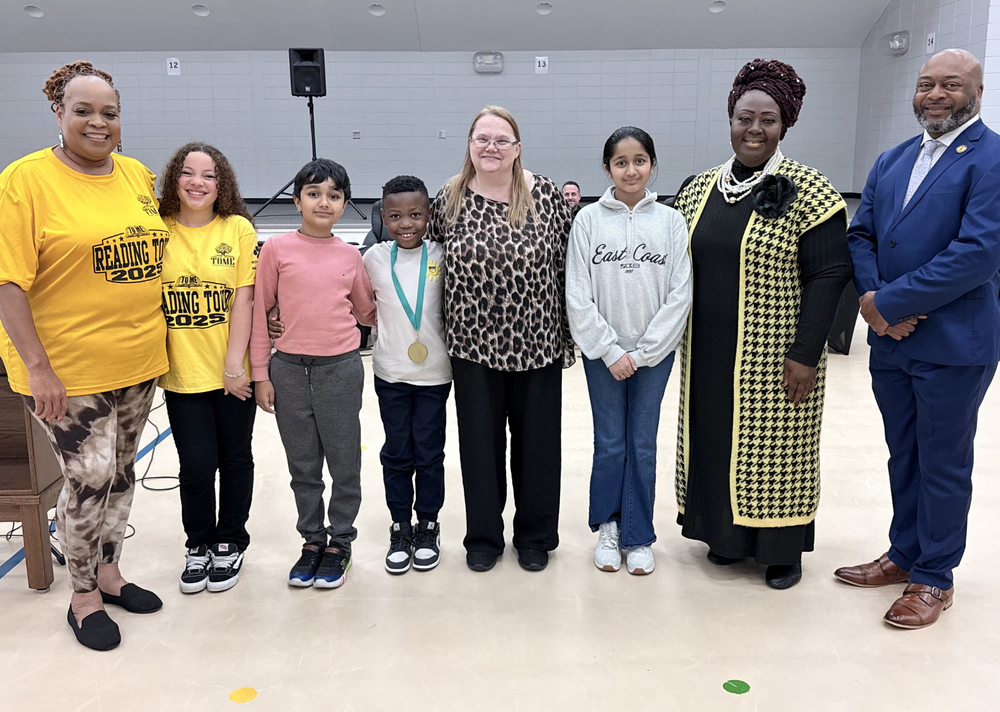 group photo of staff with students getting recognized