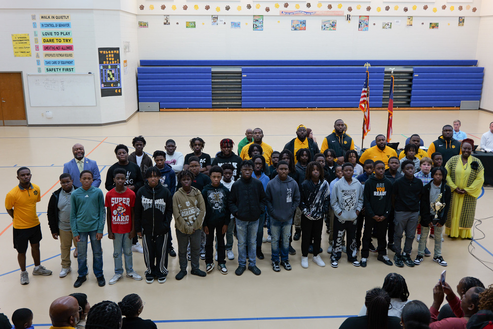 Group photo of team with coaches, Superintendent and Board Chair