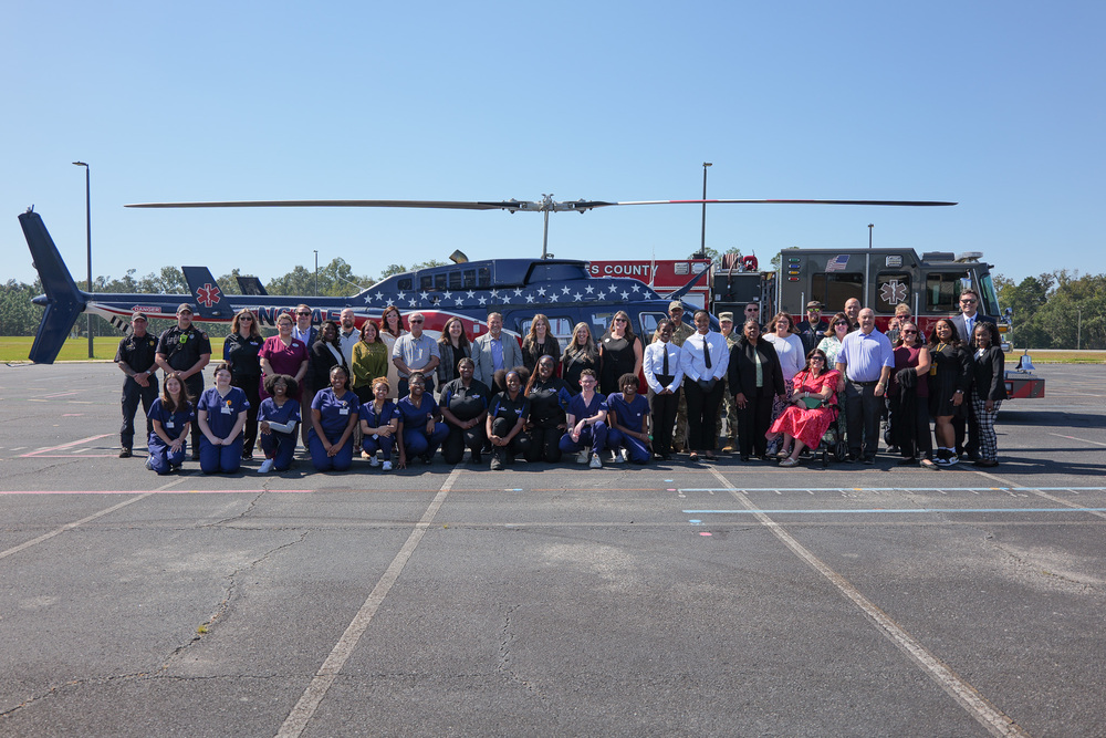 Group photo of adult participants, staff, and students