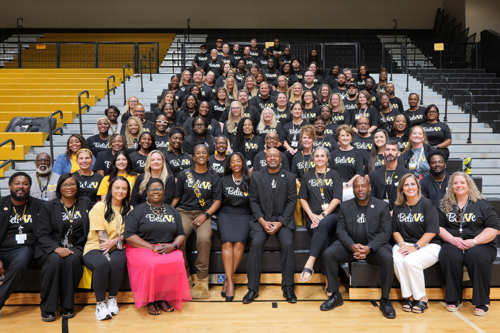 Group photo of Central Office Staff at Convocation in BelieVe In The V t-shirts