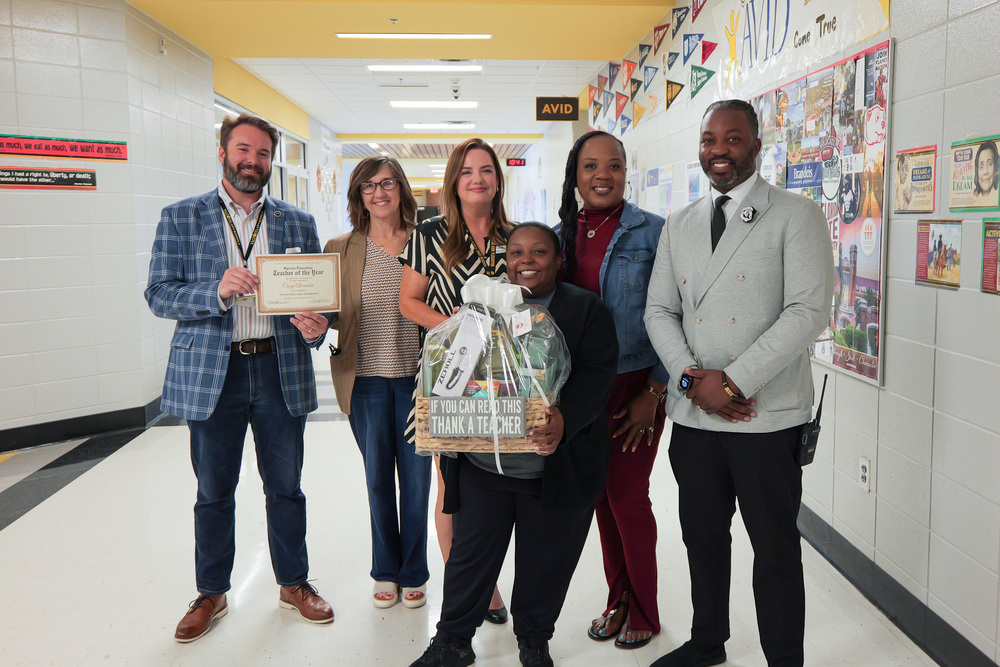 group photo with the sped teacher of the year with admin, certificate and gift basket